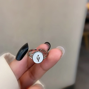 Macro shot of S925 sterling silver ring with tulip pattern on oval white shell inlay
