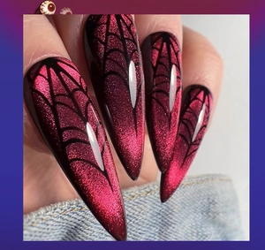 Macro shot of long stiletto press-on nails with red cat eye effect and spider web design