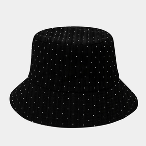 Detail shot of black bucket hat with white polka dots and premium fabric texture