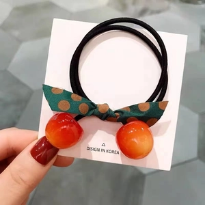 Detail of cute cherry hair tie with polka dot bow and high elastic double band