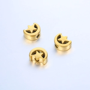 Macro shot of three golden stainless steel moon and star hollow beads for DIY jewelry