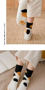 Detail of coral fleece cat paw socks with non-slip pads and soft thermal plush texture