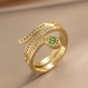 Vintage gold snake ring featuring clear zircons and emerald green gemstone eyes