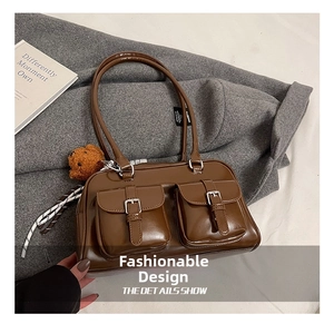 Brown vintage pillow bag featuring front pockets, a bear charm and striped ribbon detail