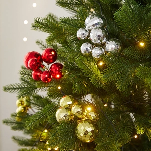Disco style multi-colored Christmas ball cluster ornaments on a festive pine tree