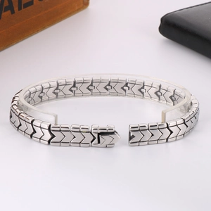 Polished silver stainless steel V-shape curb chain bracelet for men on white display