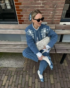 Close-up of vintage blue embroidered denim jacket paired with stylish outdoor accessories