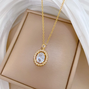 Luxurious gold titanium steel necklace featuring an oval cubic zirconia pendant in a box
