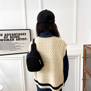 Kids black teddy fleece crossbody bag shown in a stylish minimalist lifestyle setting