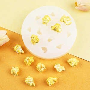Detailed view of 8-cavity popcorn silicone mold with realistic finished food models