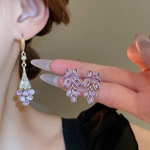 Detail of purple crystal floral earrings with marquise stones and gold plating