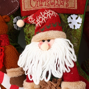 Detail of 3D Santa Claus and reindeer plush characters on knitted Christmas stocking