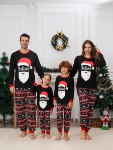 Close-up of Santa Believe print and festive snowflake reindeer pattern on family pajamas