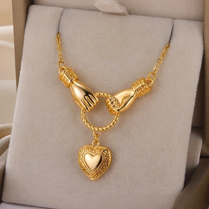 Detailed close-up of 18k gold heart pendant with relief pattern in a jewelry box