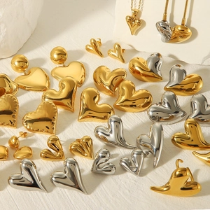 Detailed view of polished heart-shaped earrings and necklaces in gold and silver finish