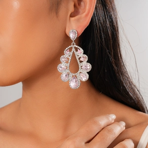 Detail of luxury teardrop silver needle earring with pink gemstones and sparkling diamonds