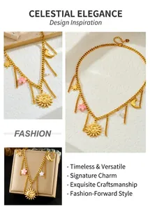Detail of gold-plated sun and moon pendants with pink flower charms on a tiered chain