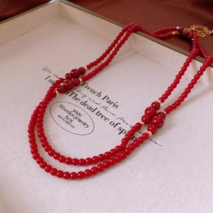 Vintage layered red bead necklace with gold spacer beads and adjustable lobster clasp