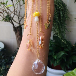 Detail of crystal suncatcher with gold butterfly, mushroom bead and faceted prism ball