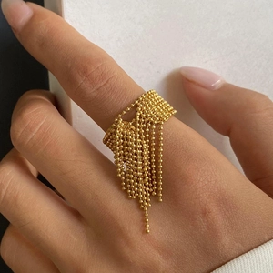 Polished gold stainless steel beaded tassel ring for women showing a dynamic drape effect