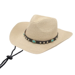 Close-up of woven straw cowboy hat with leather band, turquoise beads and wind rope