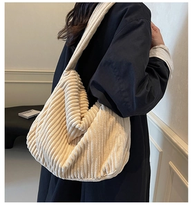 Detail of a large off-white corduroy tote bag showing its soft texture and large capacity