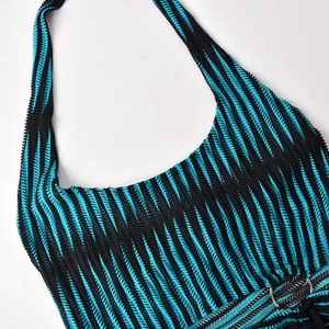 Detail of blue and black striped knit dress featuring crochet texture and metal ring waist