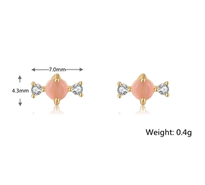 Detail view showing 7.0mm pink stone earrings in gold finish with 0.4g weight specs