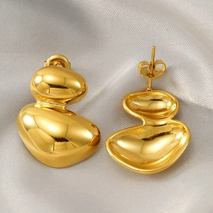 Polished gold irregular double-layered organic stud earrings on a satin background