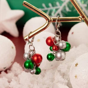 Macro view of colorful Christmas pearl earrings with red, green, and silver beads
