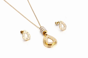 Detailed view of teardrop necklace and earrings set with inlaid diamonds in gold finish