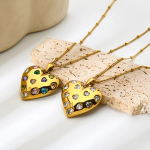 Macro shot of 18k gold plated heart pendants with colorful and white zircon inlay