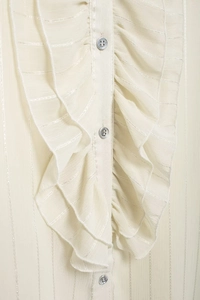 Close-up of cream white blouse featuring ruffled trim details and silver pinstripes