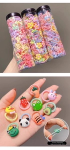 Detail of colorful cartoon hair ties set in jars with a 2cm inner diameter for kids