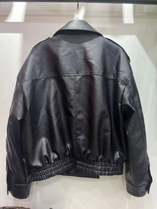Detail view of the black faux leather jacket back showing premium pebble grain texture