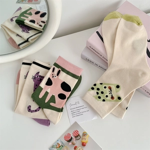 Detailed view of cute cartoon animal cotton socks with cat and rabbit illustrations