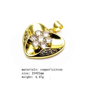 Detail of 21x21mm copper heart pendant with micro-set zircons and gold finish