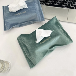 Top view of blue-grey and Morandi green velvet tissue covers with gold happiness embroidery