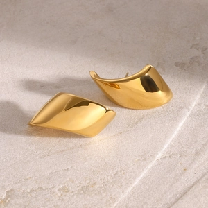 Detailed close-up of polished 18k gold plated geometric stud earrings on stone