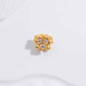 Detail showing a golden three-petal flower charm with clear zircon stones for DIY jewelry