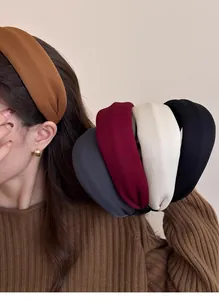Detail of wide fabric headbands in various vintage colors including brown and wine red