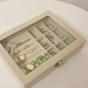 Large beige velvet jewelry organizer box with clear glass lid and nine storage sections