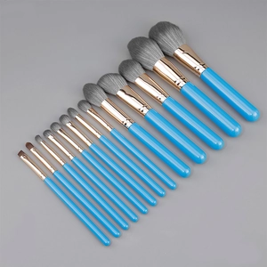 Flat lay of 13-piece sky blue makeup brush set with rose gold ferrules and soft grey bristles
