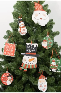 Close-up of sparkling snowman and Santa ornaments hanging on a festive Christmas tree