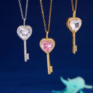 Elegant heart-shaped key pendant necklaces with sparkling zircons in silver and gold tones
