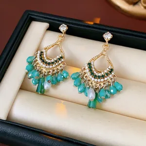 Bohemian gold hollow earrings with green teardrop beads and white pearls in a gift box