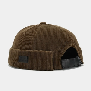 Detail view of brown corduroy dockers cap with leather patch and adjustable strap back