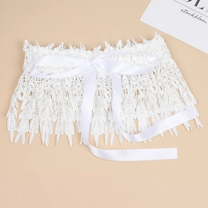 Macro view of white lace waist belt with elegant satin bow and intricate floral patterns