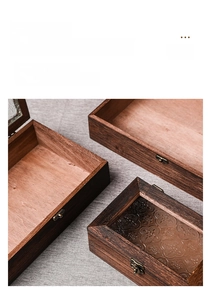 Close-up of retro wooden storage box featuring embossed floral glass and metal lock
