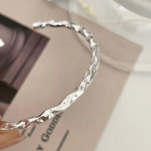 Macro detail of wave texture and hammered finish on 925 sterling silver cuff bracelet